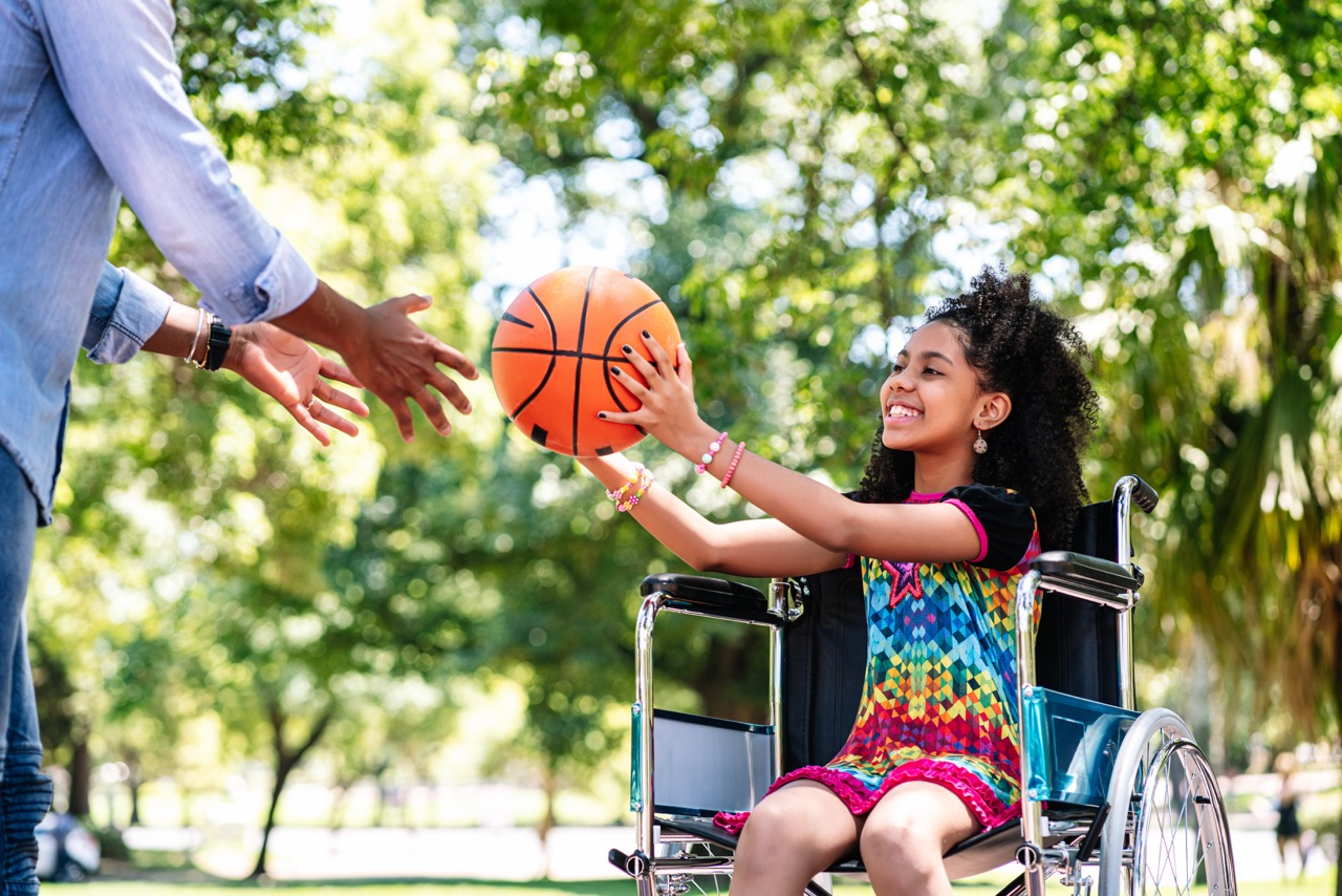 young girl in wheelchair plays ball with adult 2026 01 11 10 04 10 utc Large